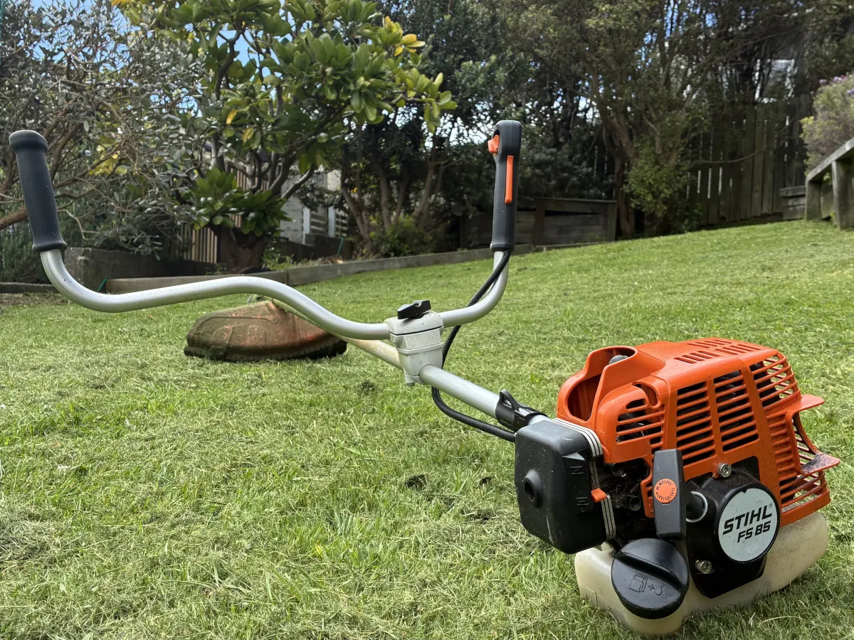 Brushcutter on a trimmed lawn